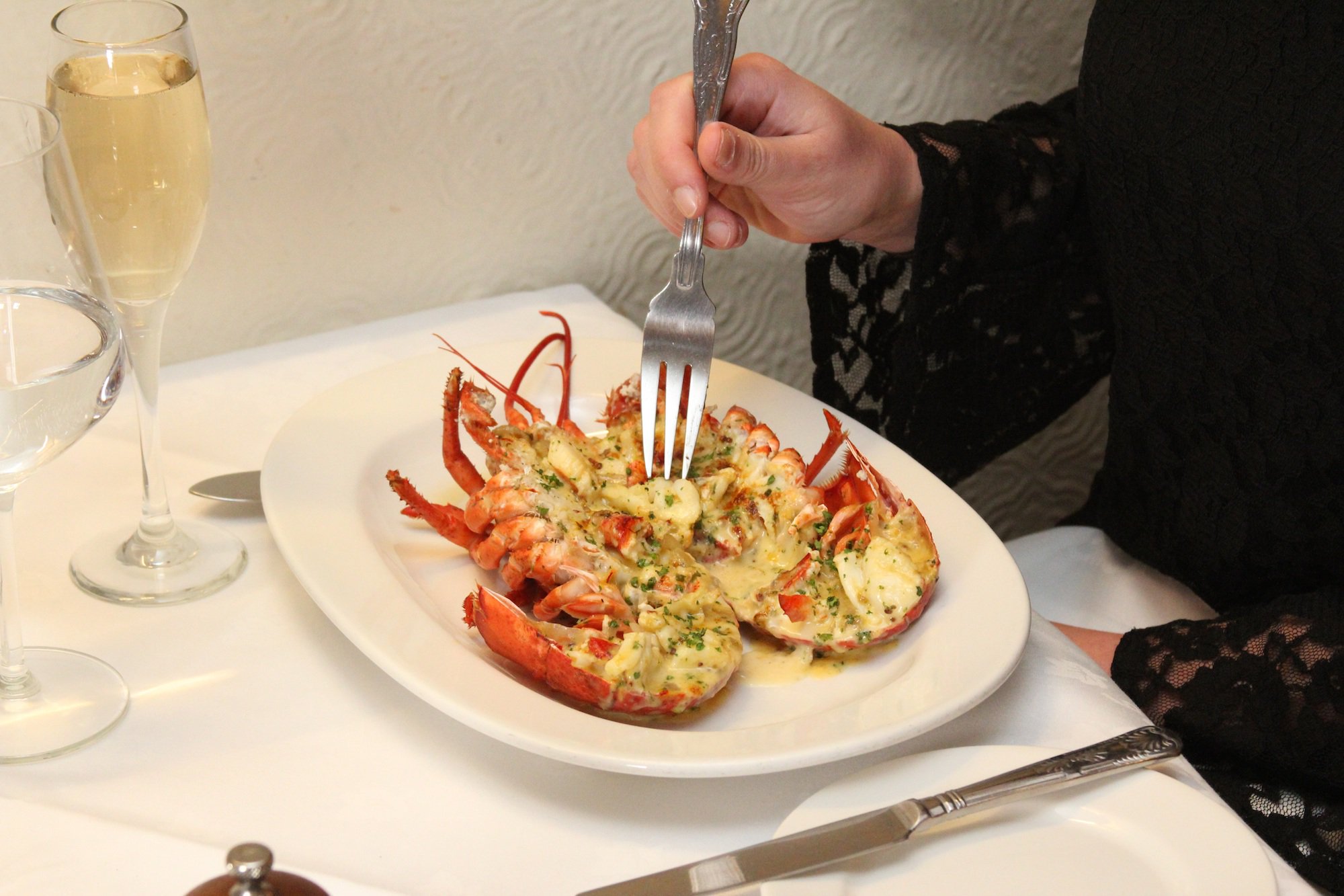 Lobster thermidor at a table about to be eaten